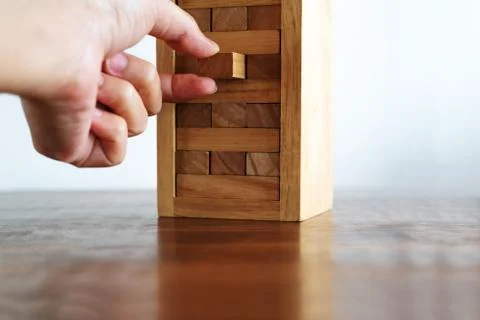 Hand fulfill a missing important piece jenga puzzle, business success concept Stock Photos