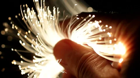 Hand full of brightly lit fibre optic cables. Fibre optics data network. Stock Footage