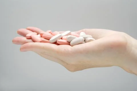 Hand full of pills Stock Photos