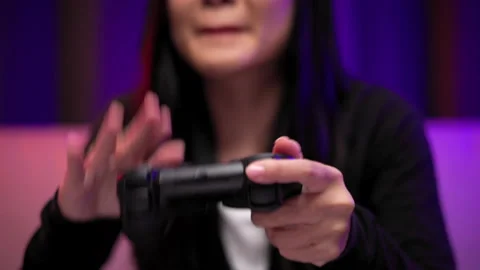 Hand gamer losing moment with controller playing video game. Woman sitting. Stock Footage 175630045