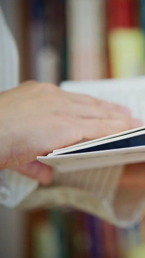 Hand gently turns page of open book Stock Footage 331523821