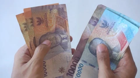 Hand gesture of counting Indonesian rupiah banknotes, closeup Stock Footage 322159559