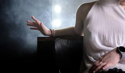 Hand gesture in the dark in backlight through the smoke. Stock Photos