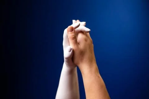 Hand gesture. Human gesture. Two hands are pressed to each other on a blue Stock Photos