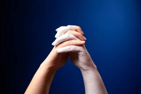 Hand gesture. Human gesture. Two hands are locked in a lock on a blue background Stock Photos