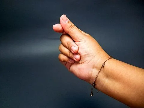 Hand gesture making a tiny heart with fingers, symbolizing affection agains.. Stock Photos