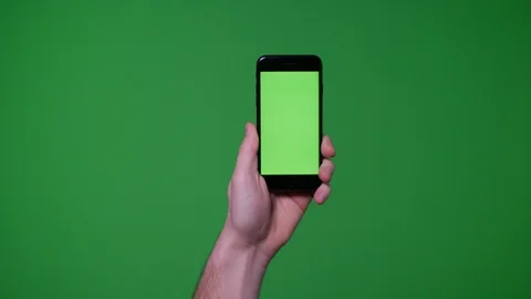 Hand gesture pack holding up smart phone device on greenscreen Stock Footage 89759217