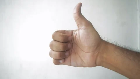 Hand gesture showing thumbs up, indicating approval, agreement, or success,.. Stock Footage 332912997