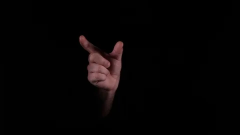Hand Gestures coming out of the dark into the light. Holding GFX object Stock Footage 92573050