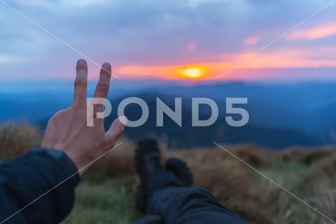 The hand gesturing on the beautiful mountain landscape background Stock Photos