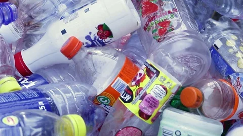 Hand getting plastic bottles to dispose in garbage bag ready to recycle. Stock Footage 119154427