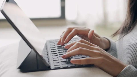Hand of girl using digital tablet to work while sitting in the living room Stock Footage 127727412