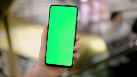 Hand of girl using smartphone with chroma key in the shopping center. Stock Footage 154074246