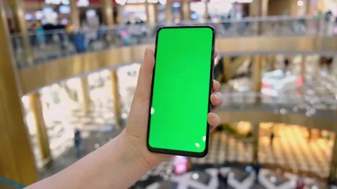 Hand of girl using smartphone with chroma key in the shopping center. Stock Footage 154074667