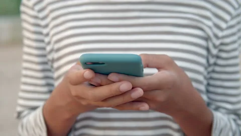 Hand of girl using smartphone close up at outdoor Stock Footage 137016902