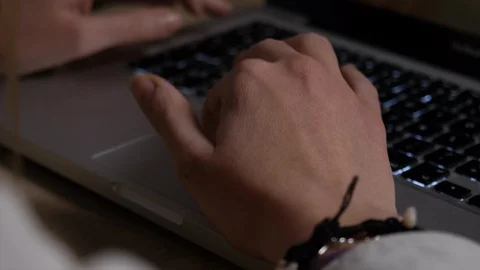 Hand girl using the trackpad on a macbook at home with bracelet and small wrist Stock Footage 87694534