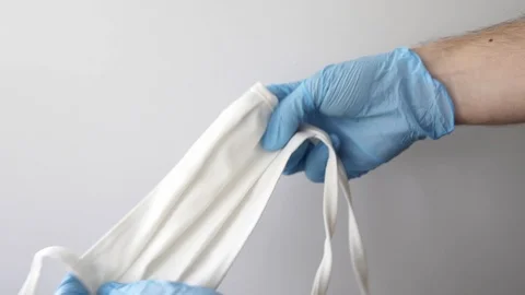 A hand give a face mask, shortage or surging high demand of respiratory mask Stock Footage 127218342