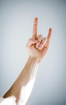 Hand giving the devil horns gesture Stock Photos