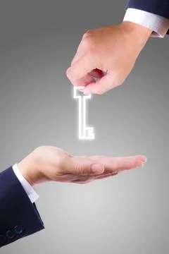 Hand giving key Stock Photos