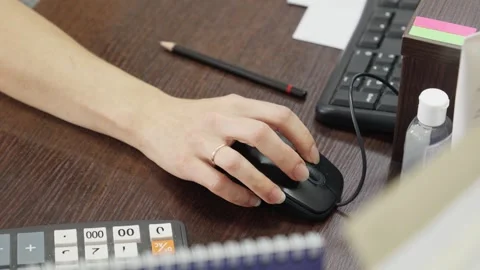 Hand glides gracefully over computer mouse at office. Bright notes and tools Video stock 284631917