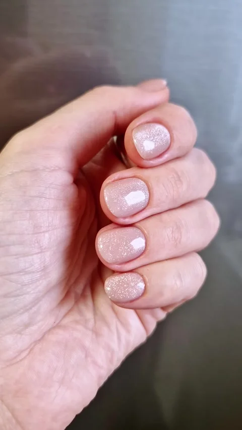Hand with Glitter Nails and Moving Light Reflection Stock Footage 321965579