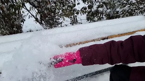 Hand in the glove brushing snow off the bench. Stock Footage 222748306