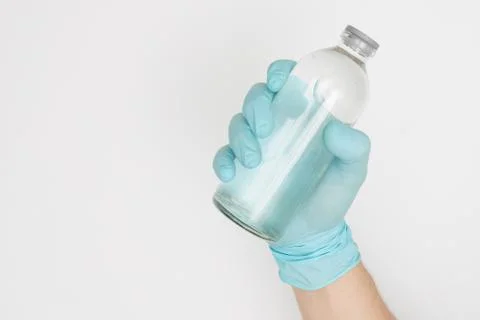 Hand in glove with nat solution on white background covid-19 coronavirus Stock Photos
