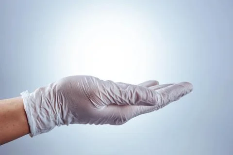Hand in glove presenting empty space for advertising Fotos Stock