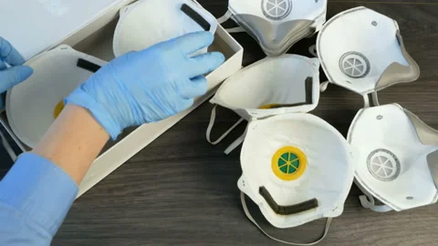 Hand in gloves and many different respirators with high protection level. Pro Video stock 147439625