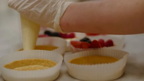 Hand in gloves are adding custard Stock-Footage 138457117