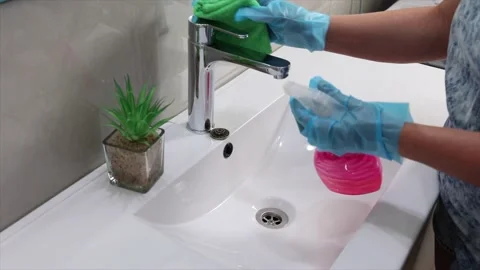 Hand in gloves cleaning tap and washbasin.slow motion Stock Footage 220150701