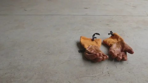 Hand gloves lying on floor Stock Footage 83866088