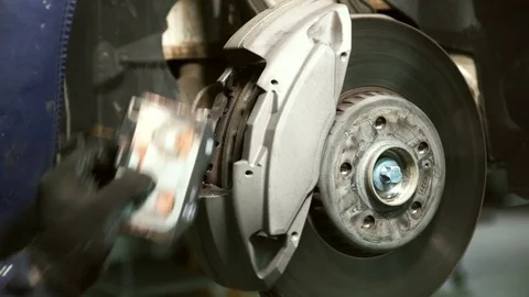 Hand gloves makes replacing brake pads on wheel. Stock Footage 81138264