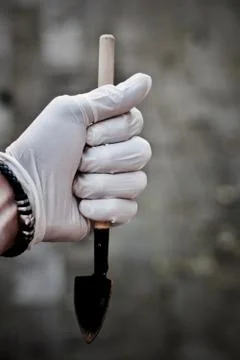 Hand in gloves with spade Stock Photos