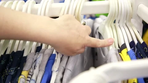 A hand goes through the hangers Stock Footage 134468934