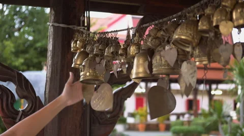 Hand going through bells at Buddhist Temple Stock Footage 56356974