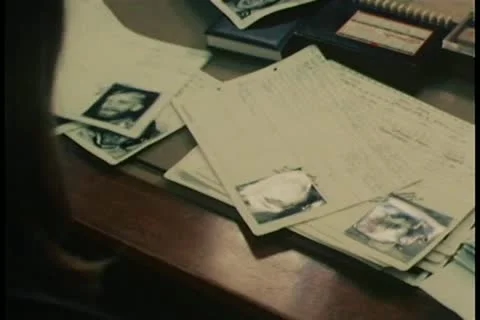 Hand going through documents with photos attached Stock-Footage 11349294