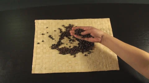 Hand Going Through Roasted Coffee Beans On A Bamboo Cover Above-Shot Vídeo Stock 34609693