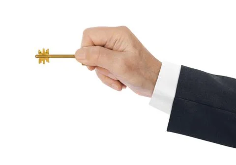 Hand with gold key Stock Photos