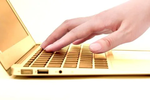 Hand in the golden notebook computer Stock Photos