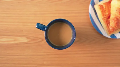Hand grab cup of coffee fast on table with bread breakfast Stock-Footage 158378958