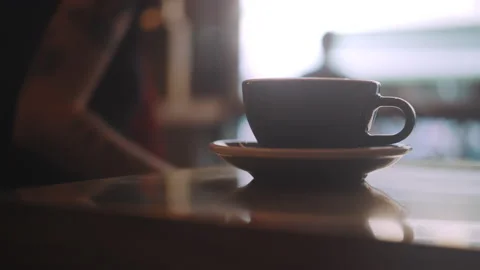 Hand grabbing coffee cup from table Stock Footage 203587034