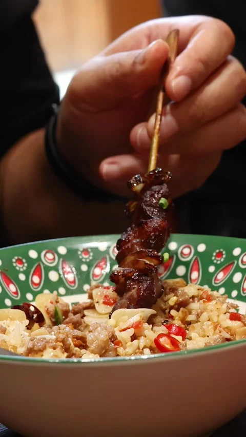 Hand Grabbing Grilled Beef Skewer Over Thai Rice Meal Stock Footage 315726152