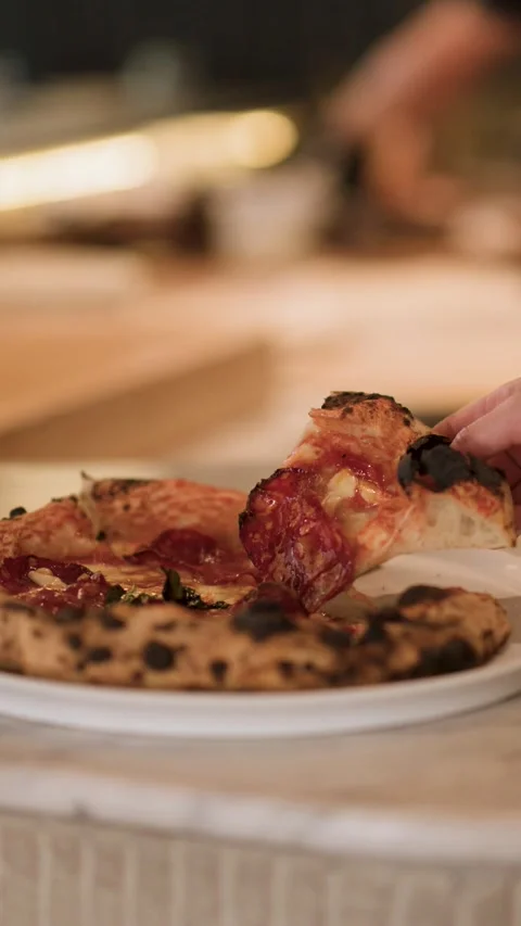 Hand Grabbing Salami Pizza Slice from Marble Counter in Restaurant Stock Footage 340244218