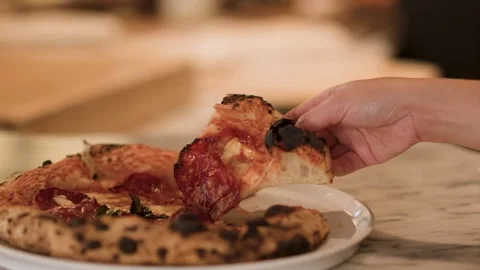 Hand Grabbing Slice of Neapolitan Pepperoni Pizza in Italian Restaurant Stock Footage 340863676