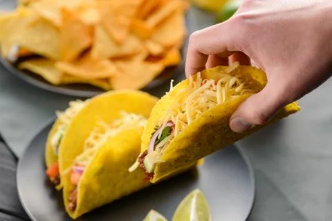 Hand grabbing a taco shell Stock Photos