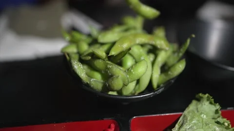 Hand grabs edamame close up Stock Footage 157342373