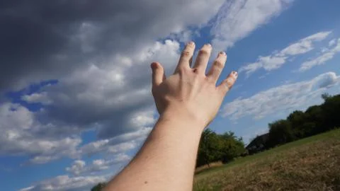 Hand grabs the sky Stock Photos
