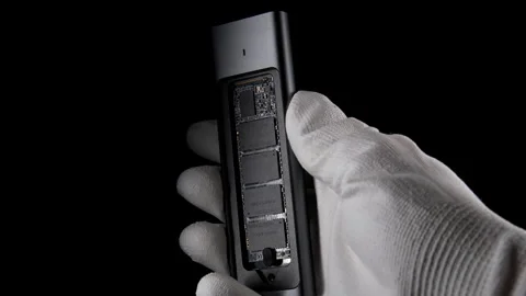 Hand Grasping Open SSD Case with inside M.2, External USB Drive on black Stock Footage 270469629