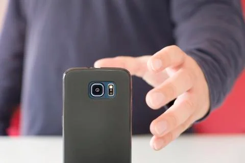 Hand grasping a smartphone Stock Photos